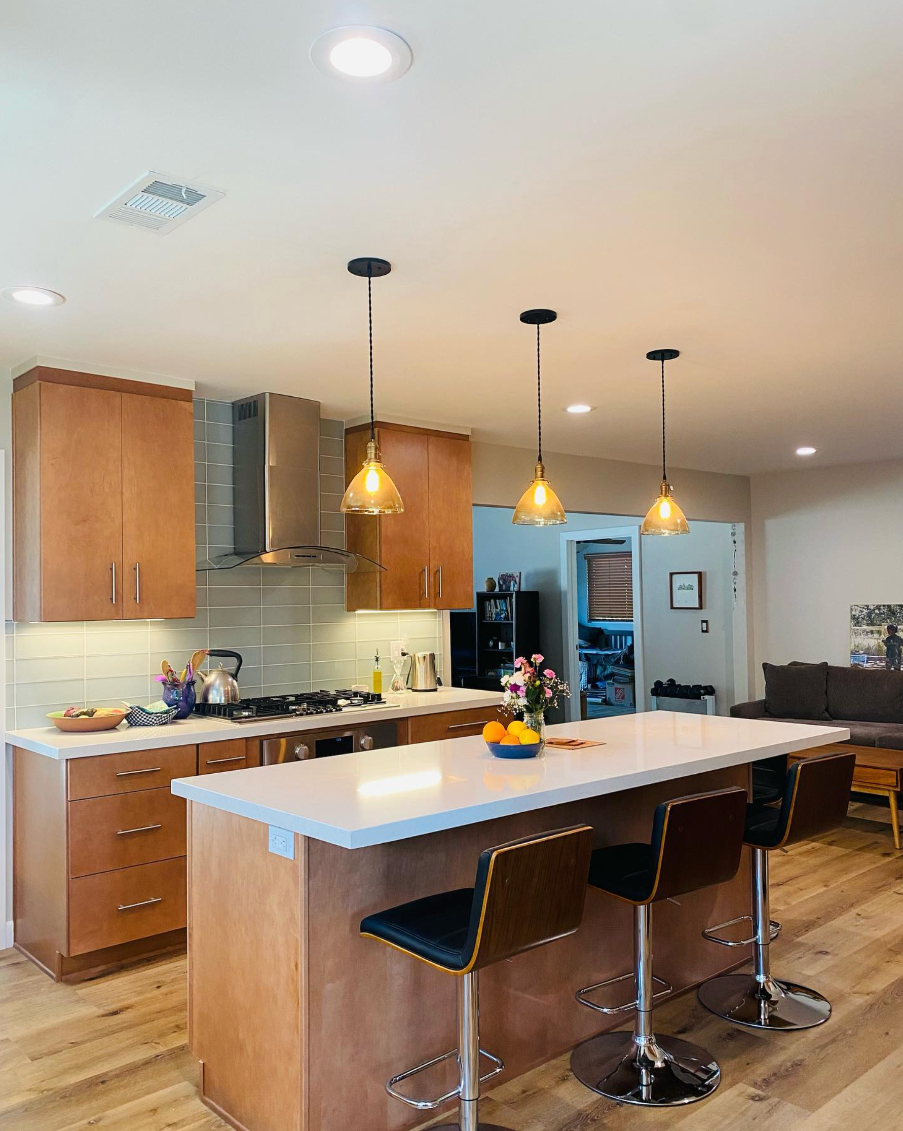 A kitchen with a large island and stools