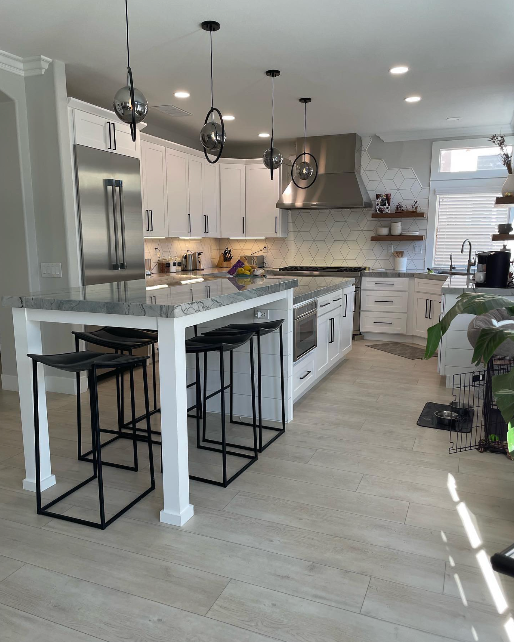 A kitchen with a table and stools in it