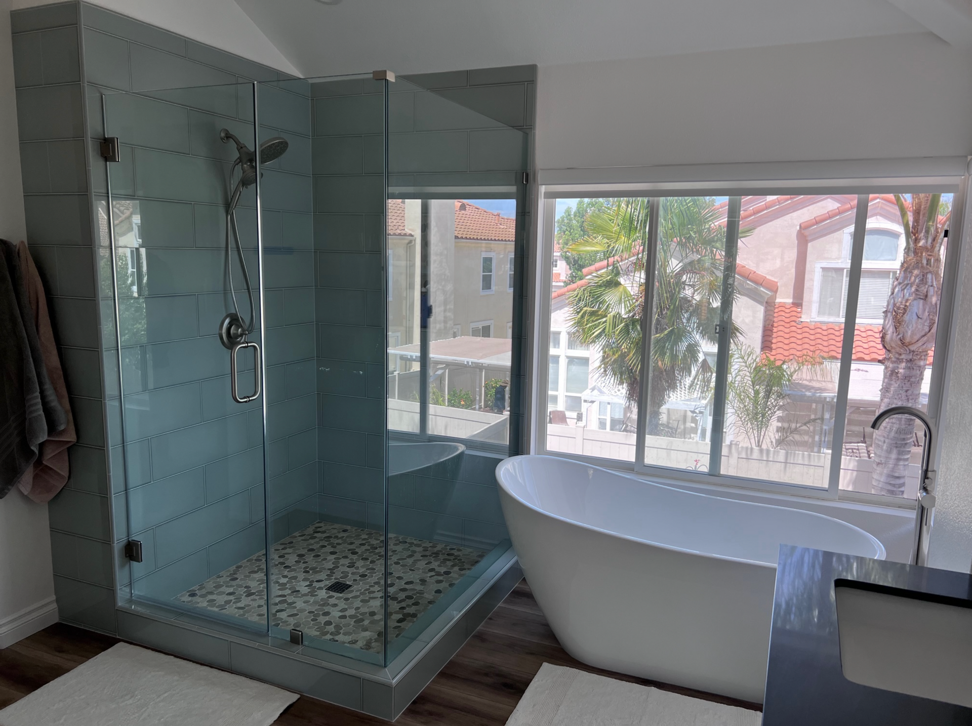 A bathroom with a tub , shower , and window.