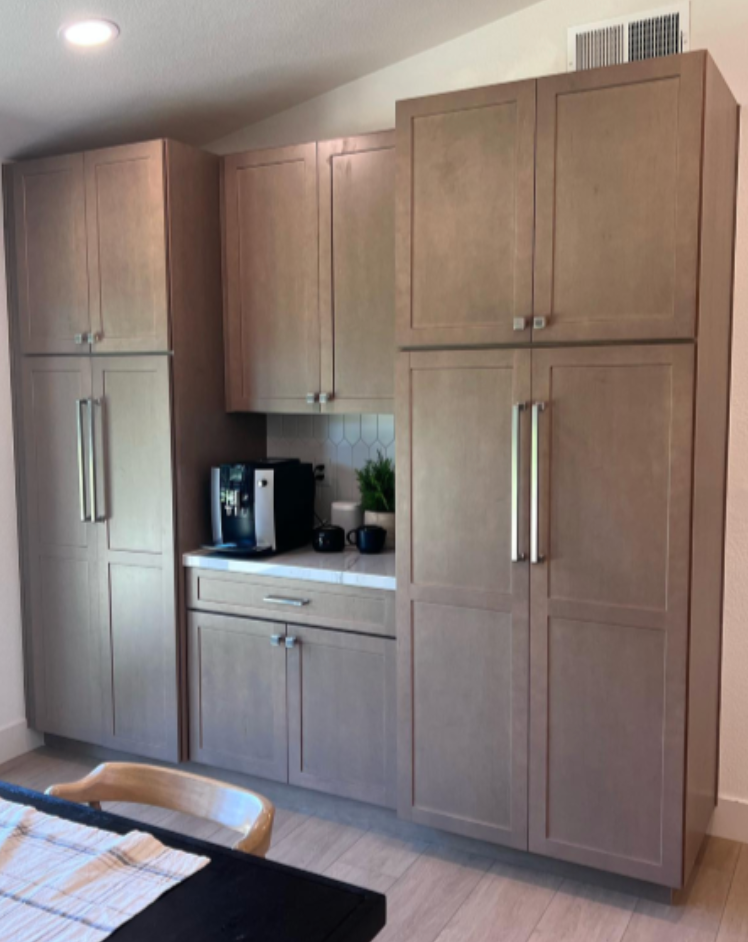 A kitchen with lots of cabinets and a coffee maker