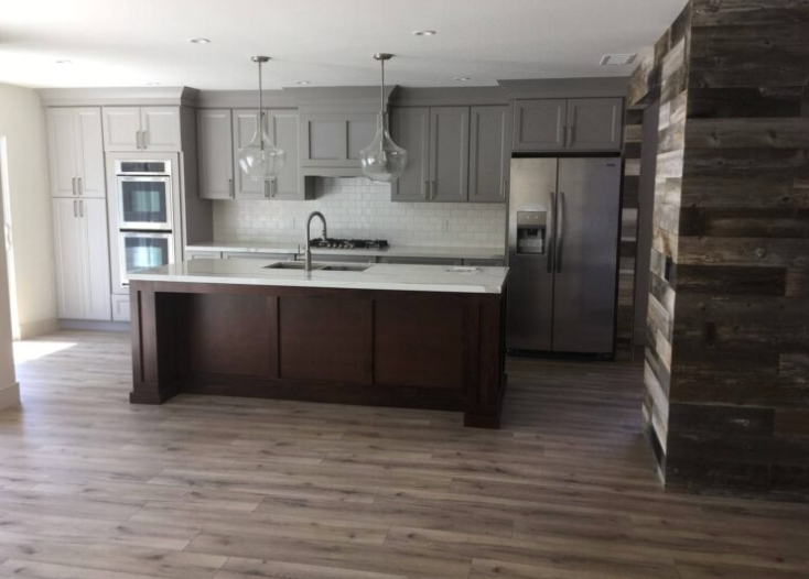 A kitchen with a large island and stainless steel appliances