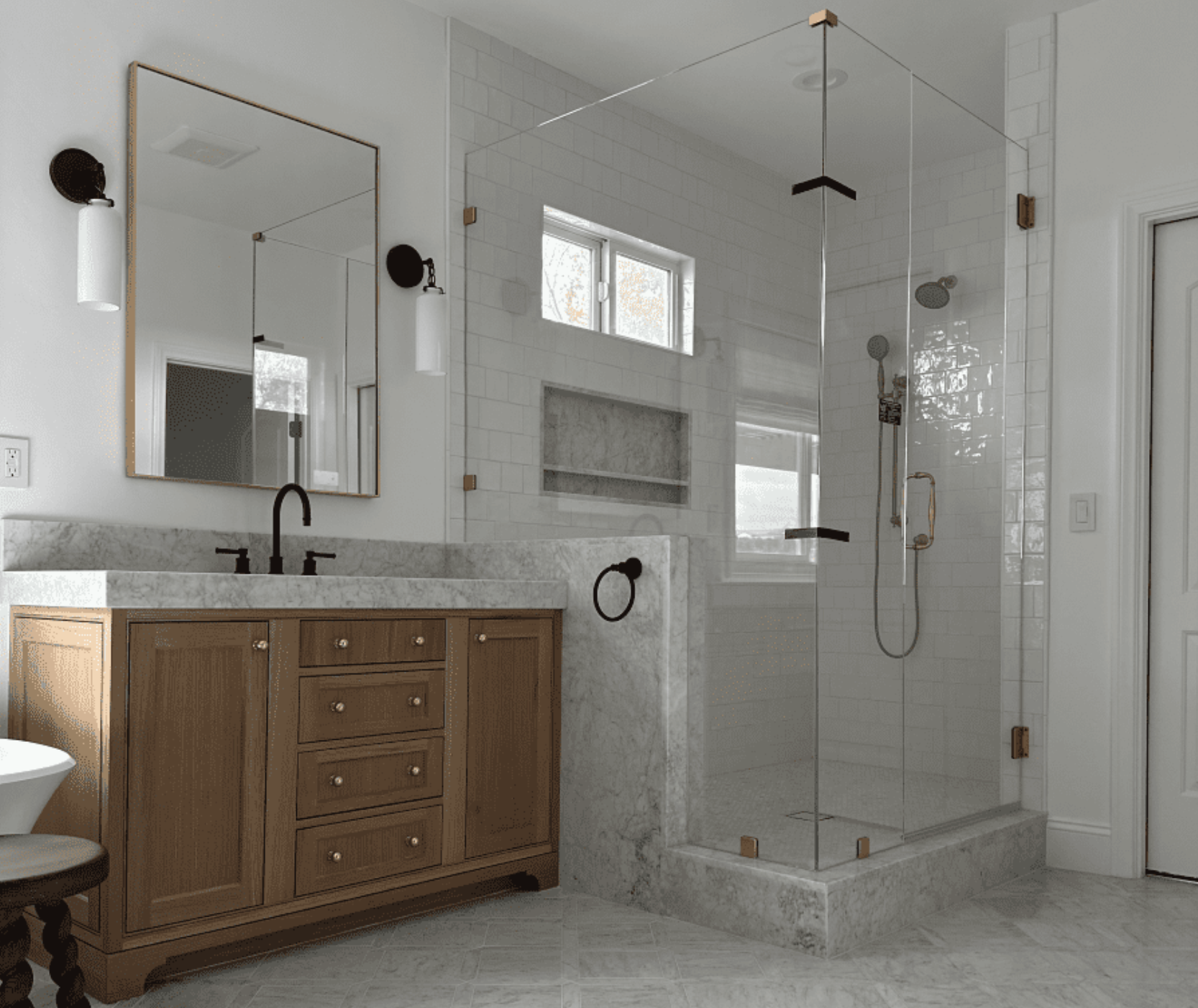 A bathroom with two sinks , a walk in shower and a large mirror.