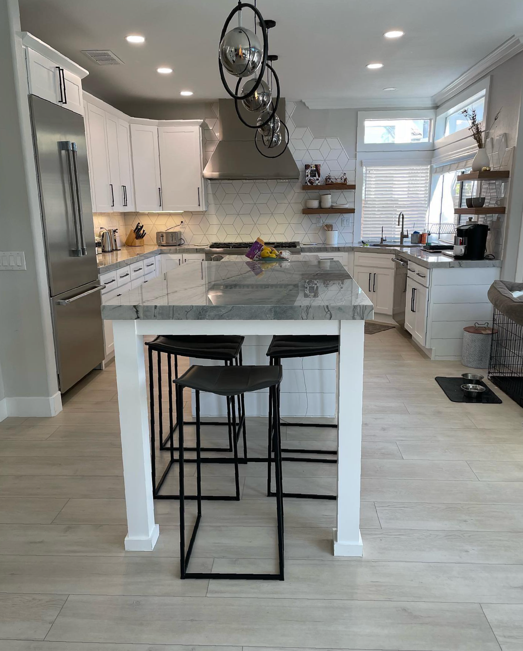 A kitchen with a large island and stools