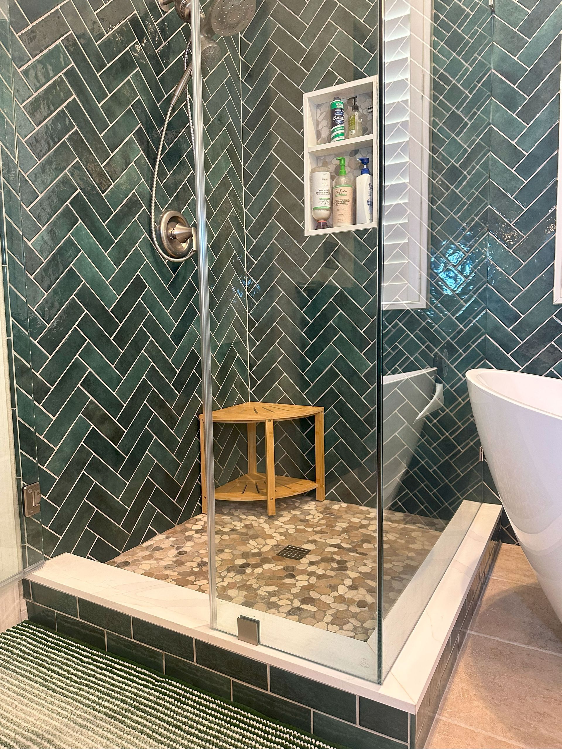 Bathroom shower with green tiles