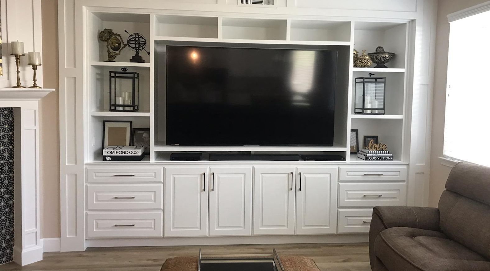 A living room with a large flat screen tv on the wall.