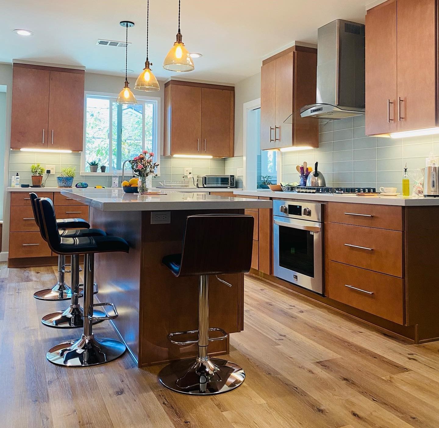 A kitchen with a large island and stools