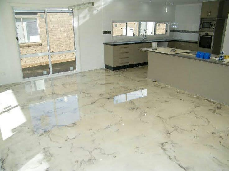 Bright modern kitchen with glossy marble floor, white walls, and large windows.