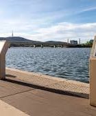 A large body of water with a bridge in the background.