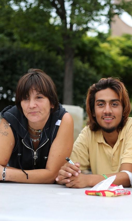 A man and a woman are sitting at a table.