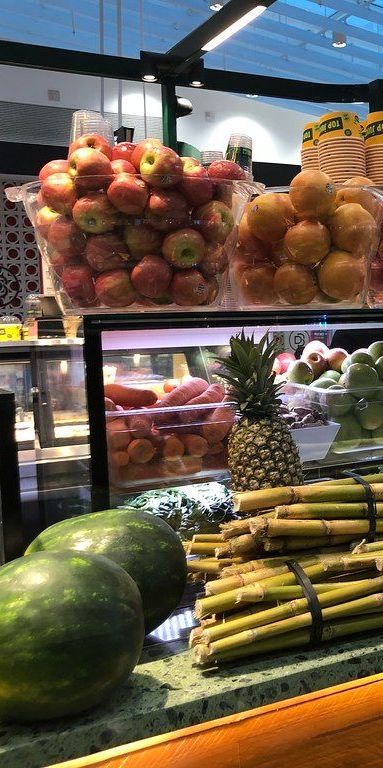 A variety of fruits and vegetables are displayed in a store.