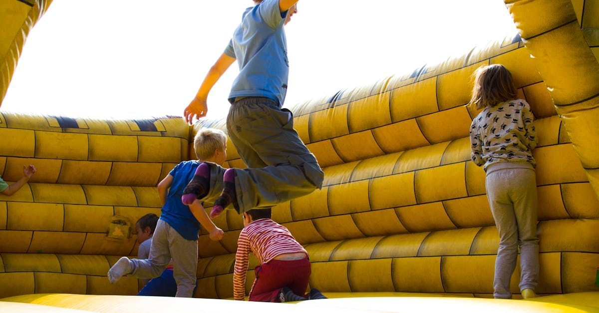 A group of children are jumping in a bouncy house. SIL – Supported Independent Living, NDIS, Canberra