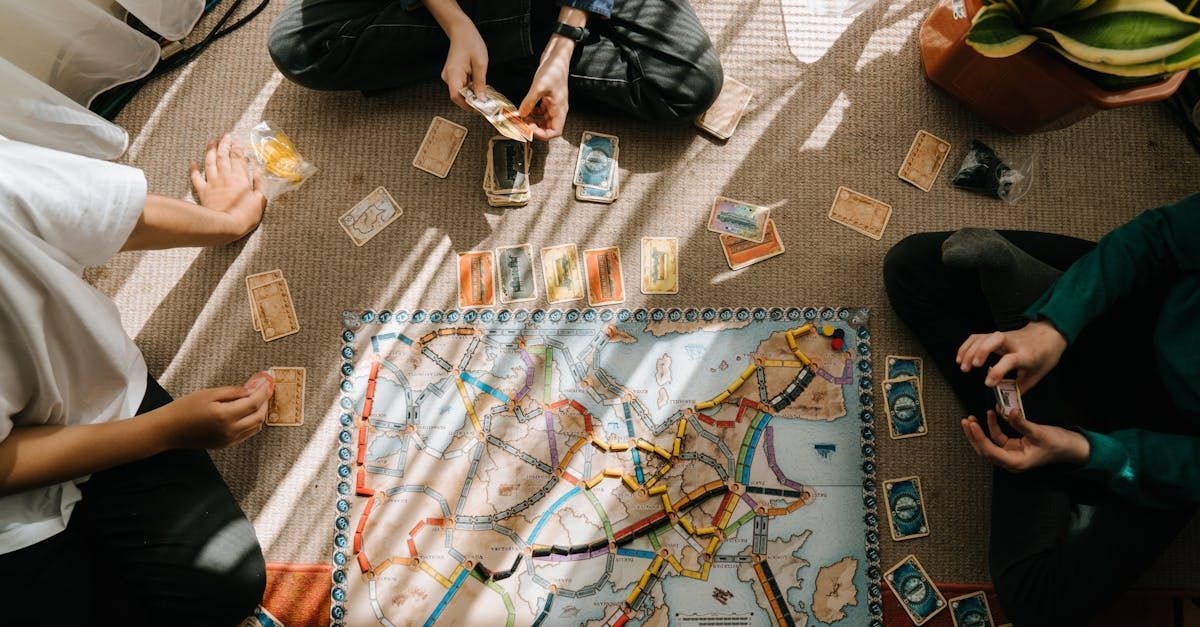 A group of people are sitting on the floor playing a board game.