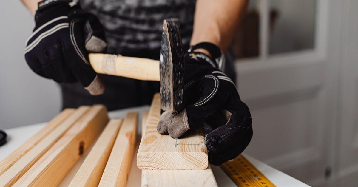 A person is hammering a nail into a piece of wood, NDIS support in Canberra.