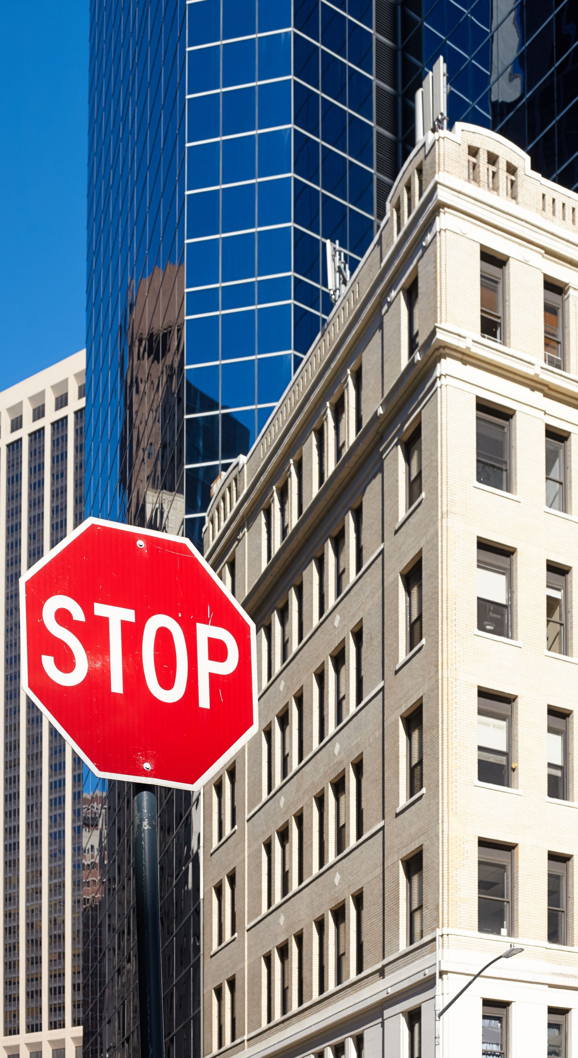 A stop sign in front of a building in a city