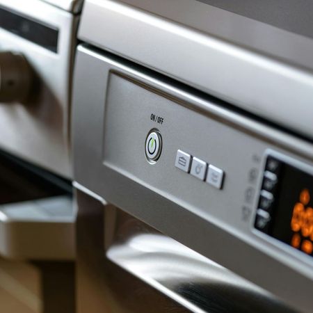 A close up of a dishwasher with a power button