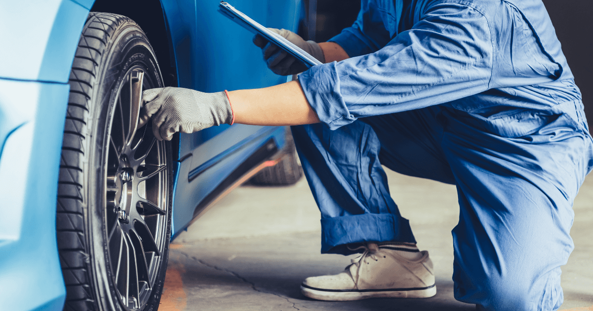 Mechanic doing a used car inspection