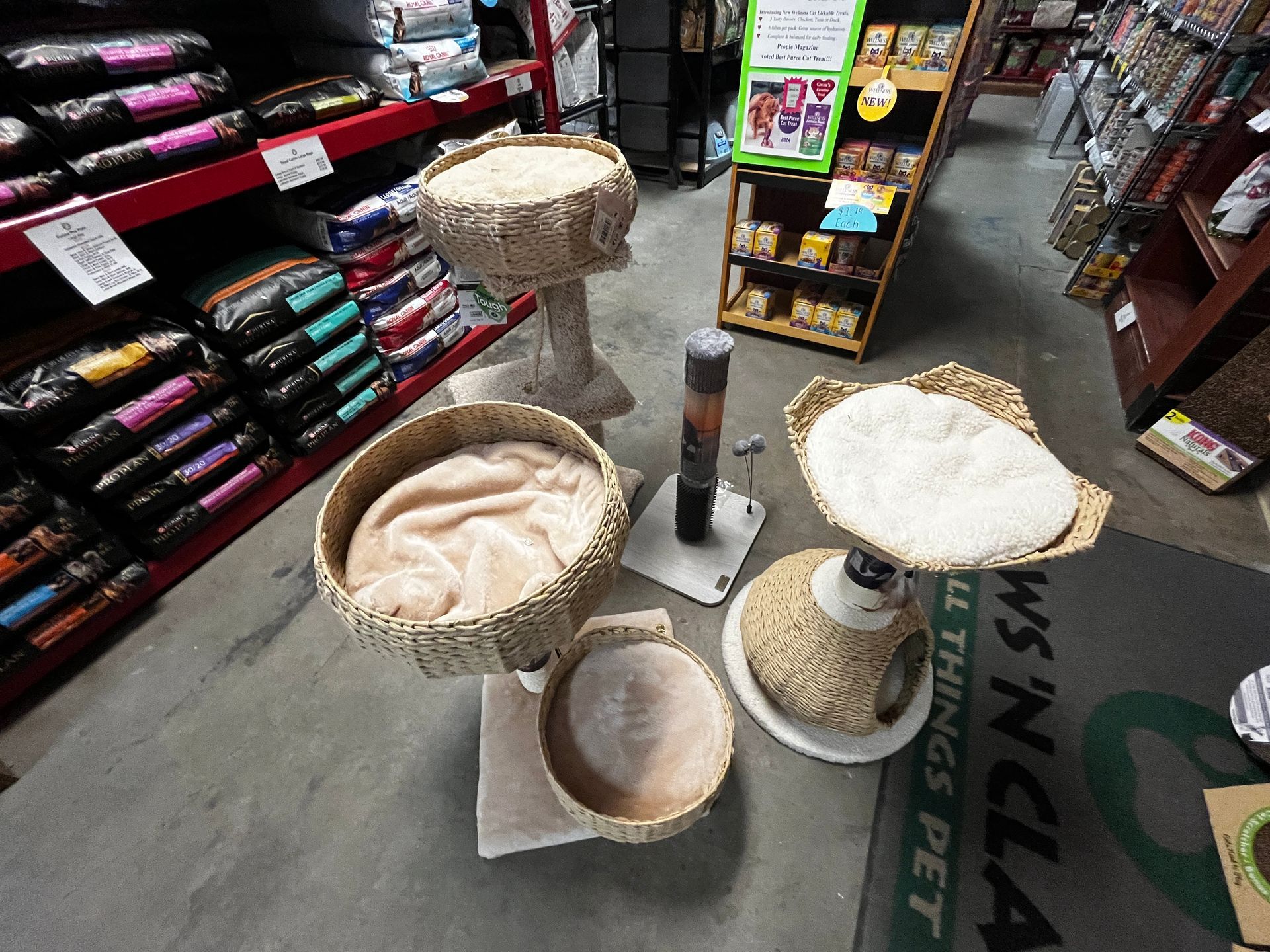 A cat tree in a store with a sign that says things pet