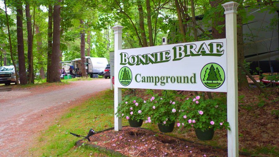 A sign for bonnie brae campground in the woods