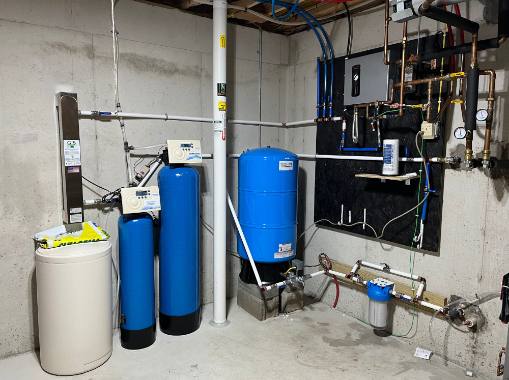 A room with a lot of pipes and tanks in it.