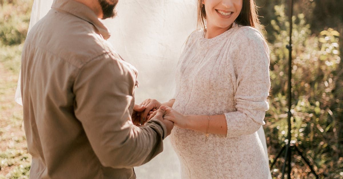 A man is putting a ring on a woman 's finger.