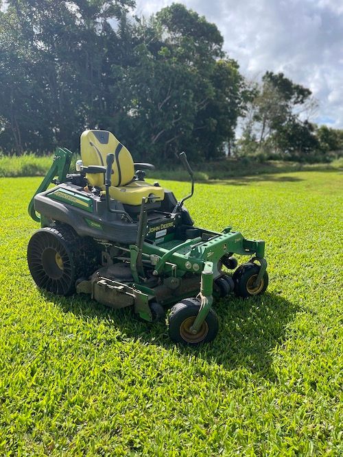 Gardener Wearing Protective Ear Muffs While Mowing — Gardeners in Tully, QLD