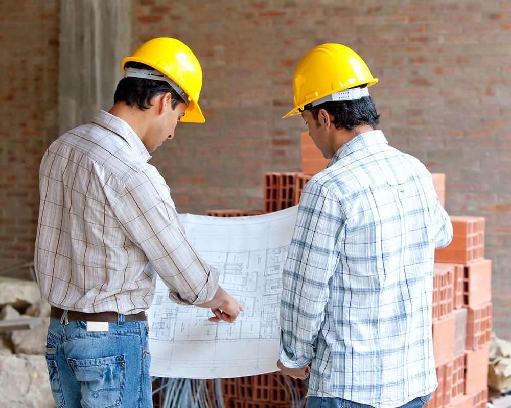 Architects at a Construction Site Looking at Blueprints
