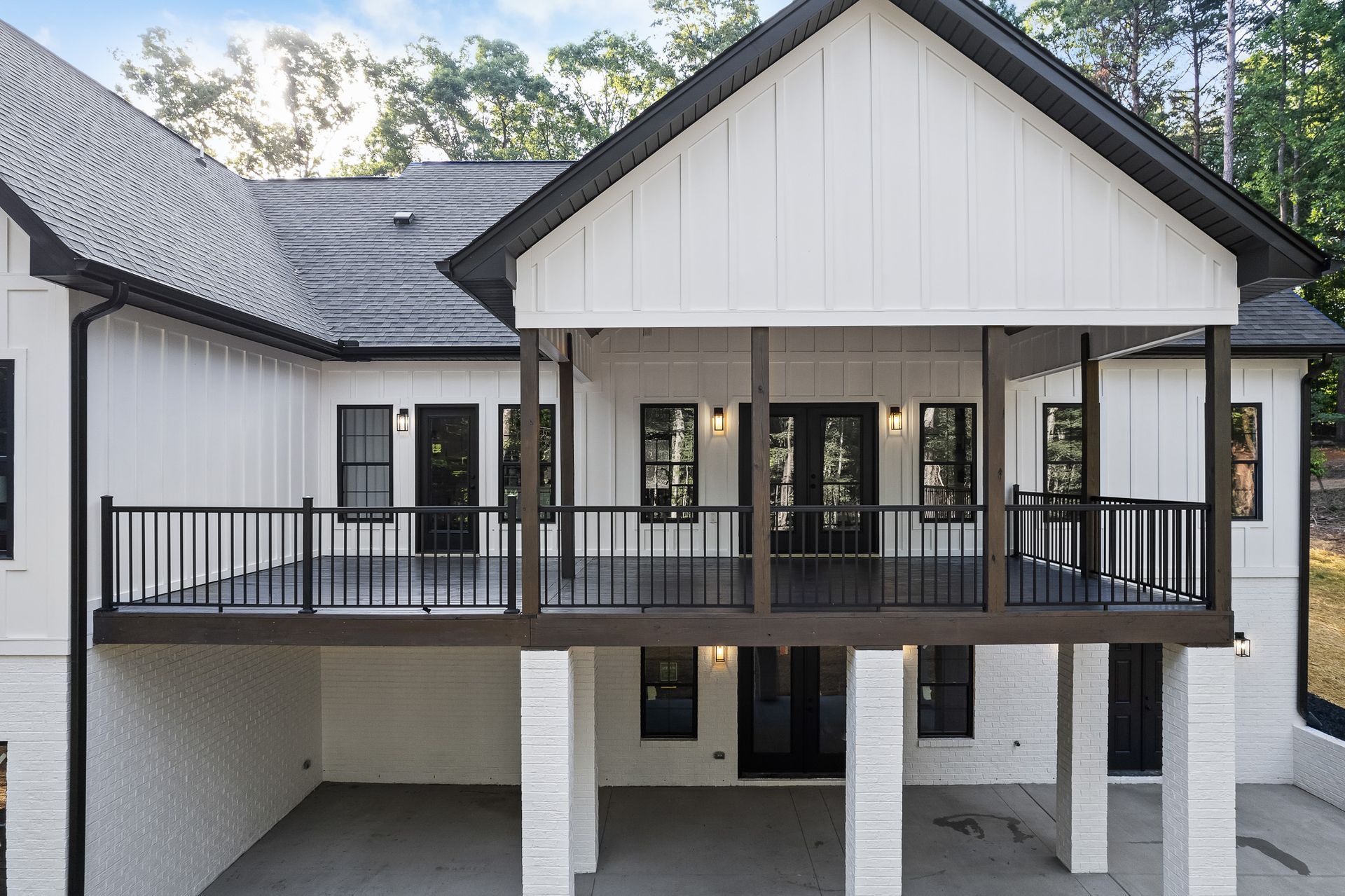 A white house with a balcony and a black railing