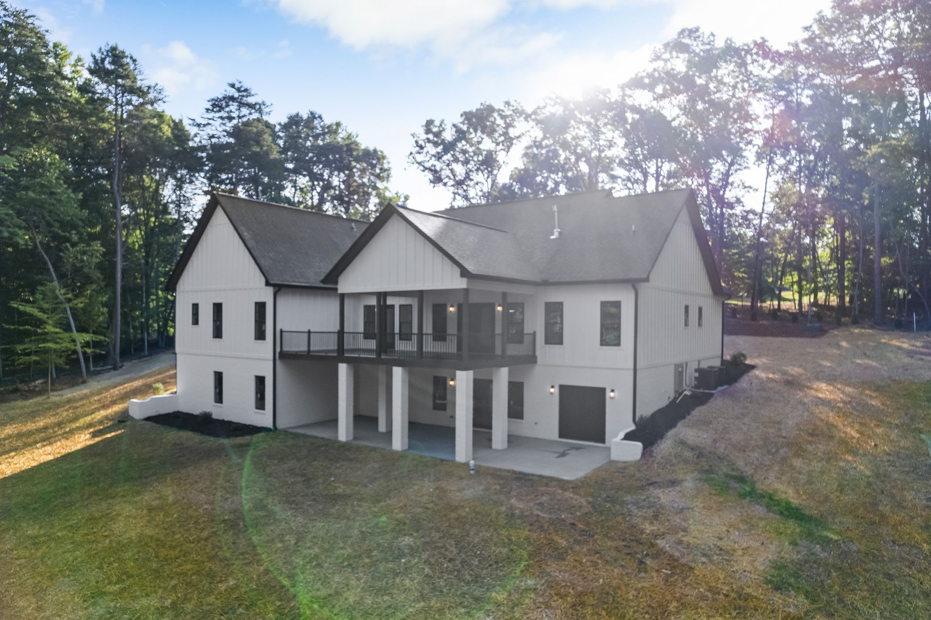 An aerial view of a large white house surrounded by trees.