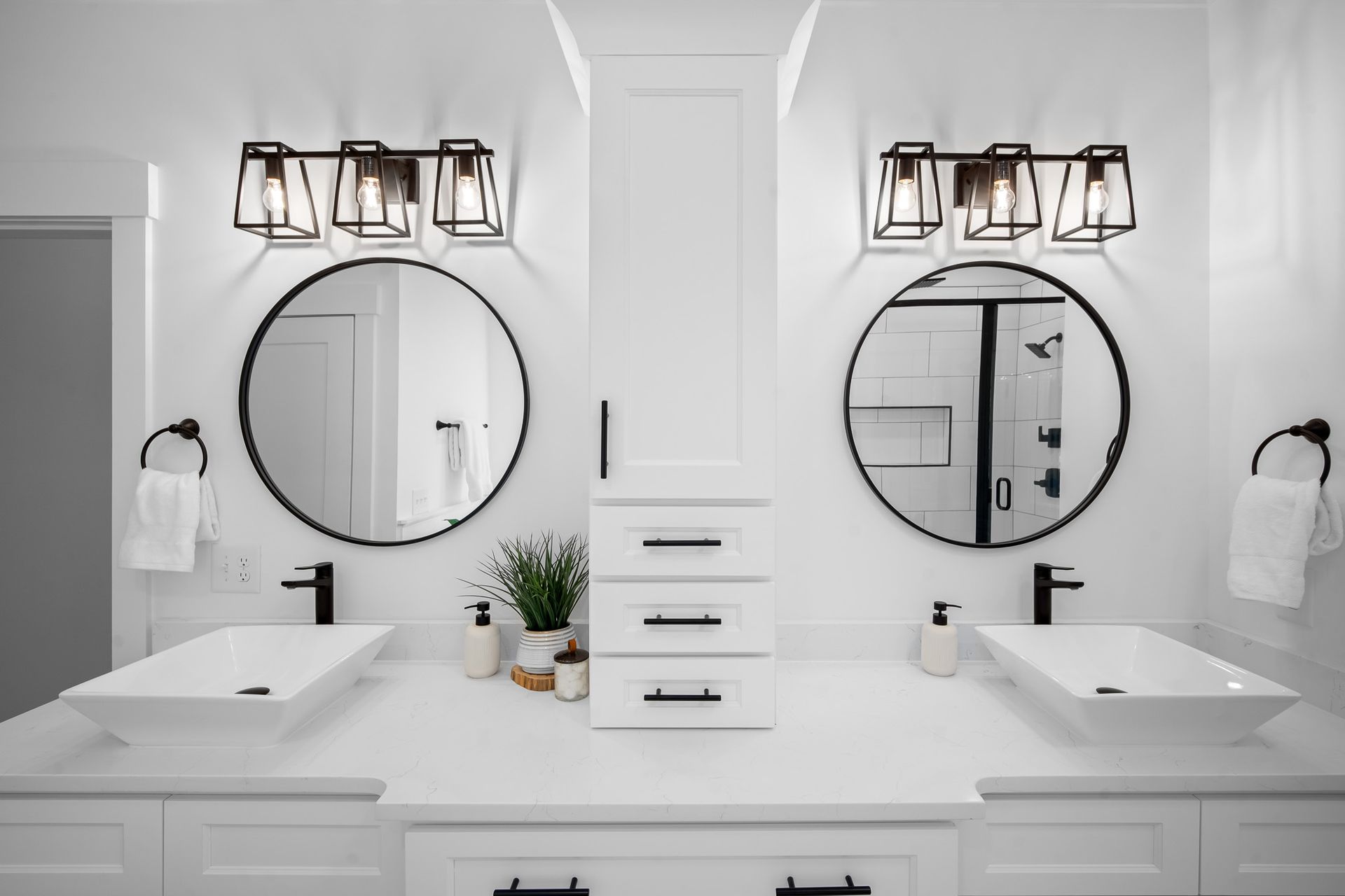 A bathroom with two sinks and two mirrors.