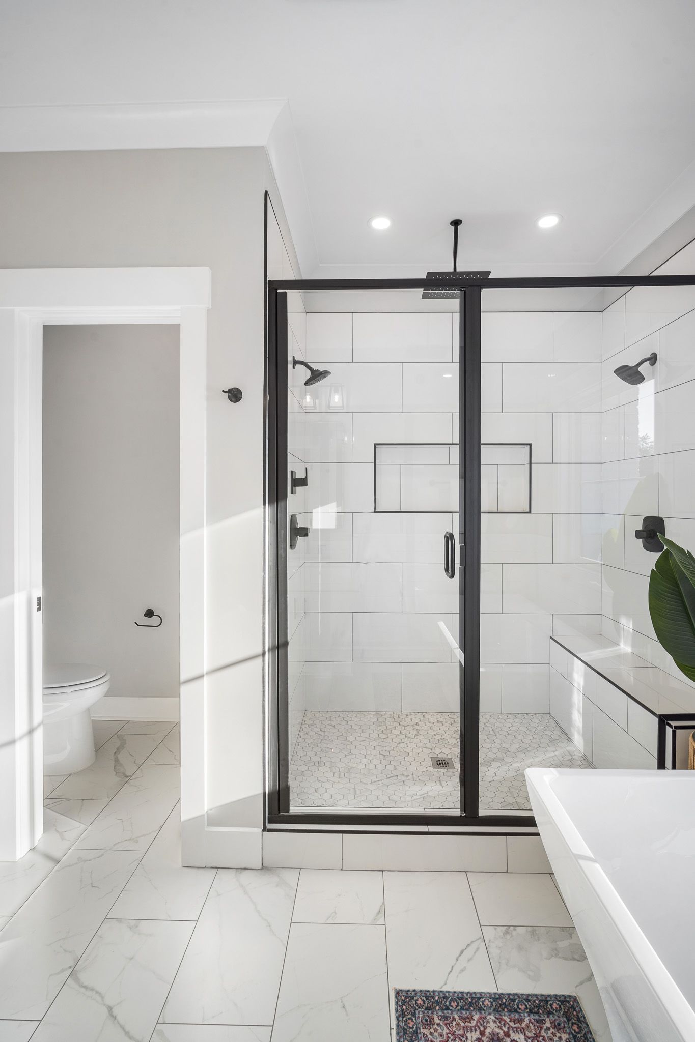 A bathroom with a walk in shower and a bathtub.