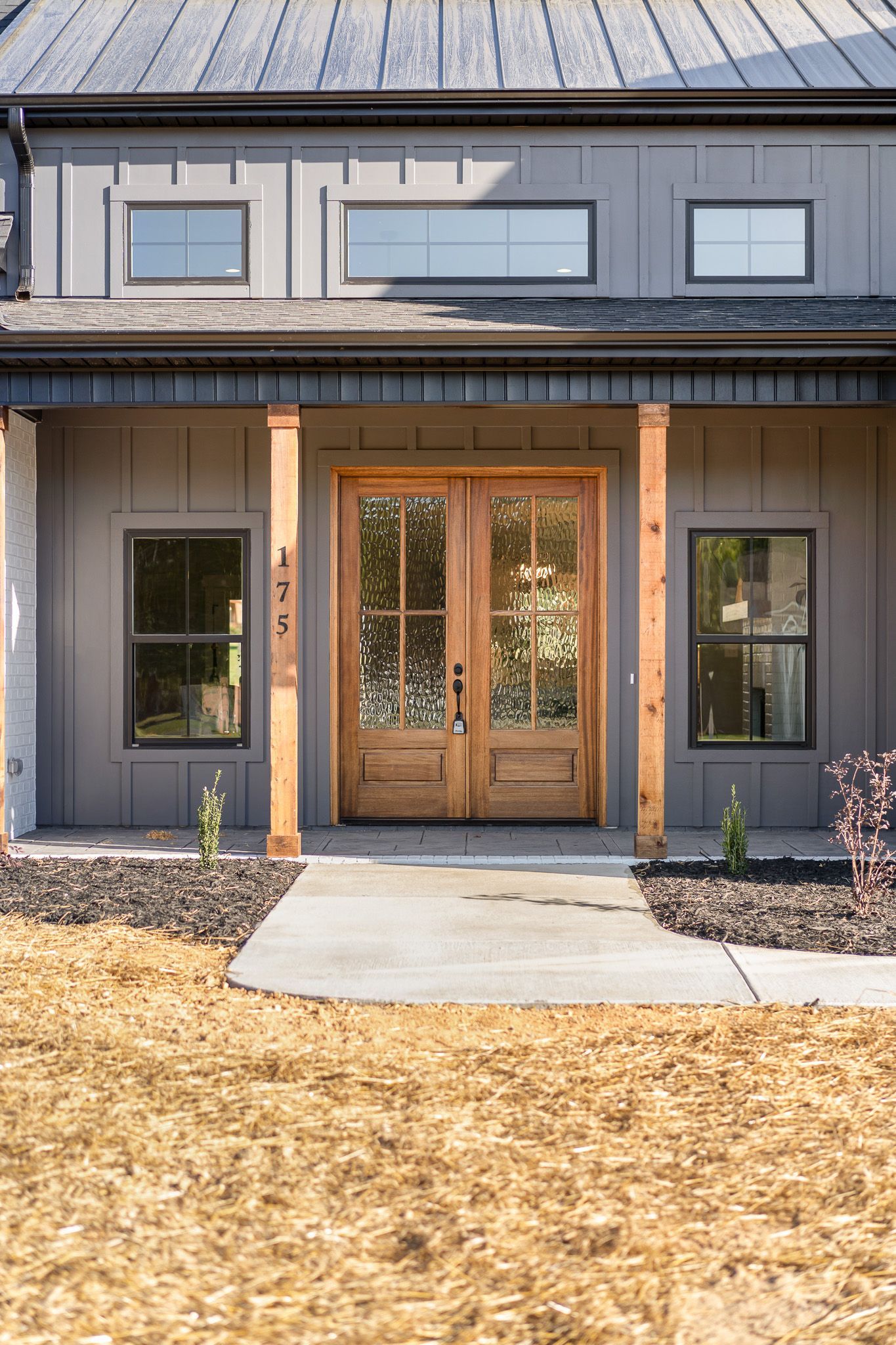 The front of a house with a porch and a wooden door
