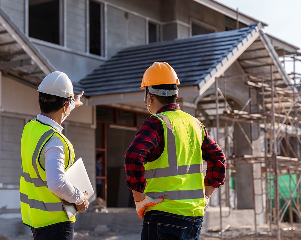 Worker Inspecting House Construction
