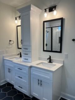 A bathroom with two sinks and a mirror