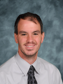 a man in a white shirt and tie smiles for the camera