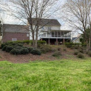 A large house with a large lawn in front of it.