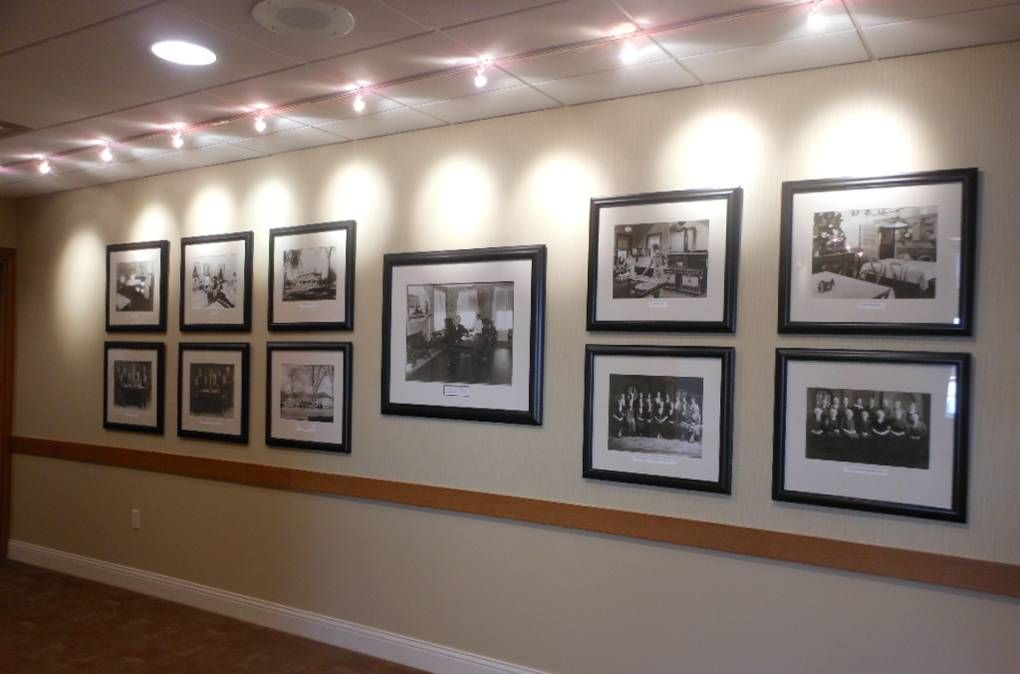 A hallway with many framed pictures on the wall