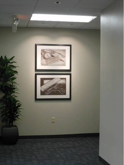 A hallway with two framed pictures on the wall