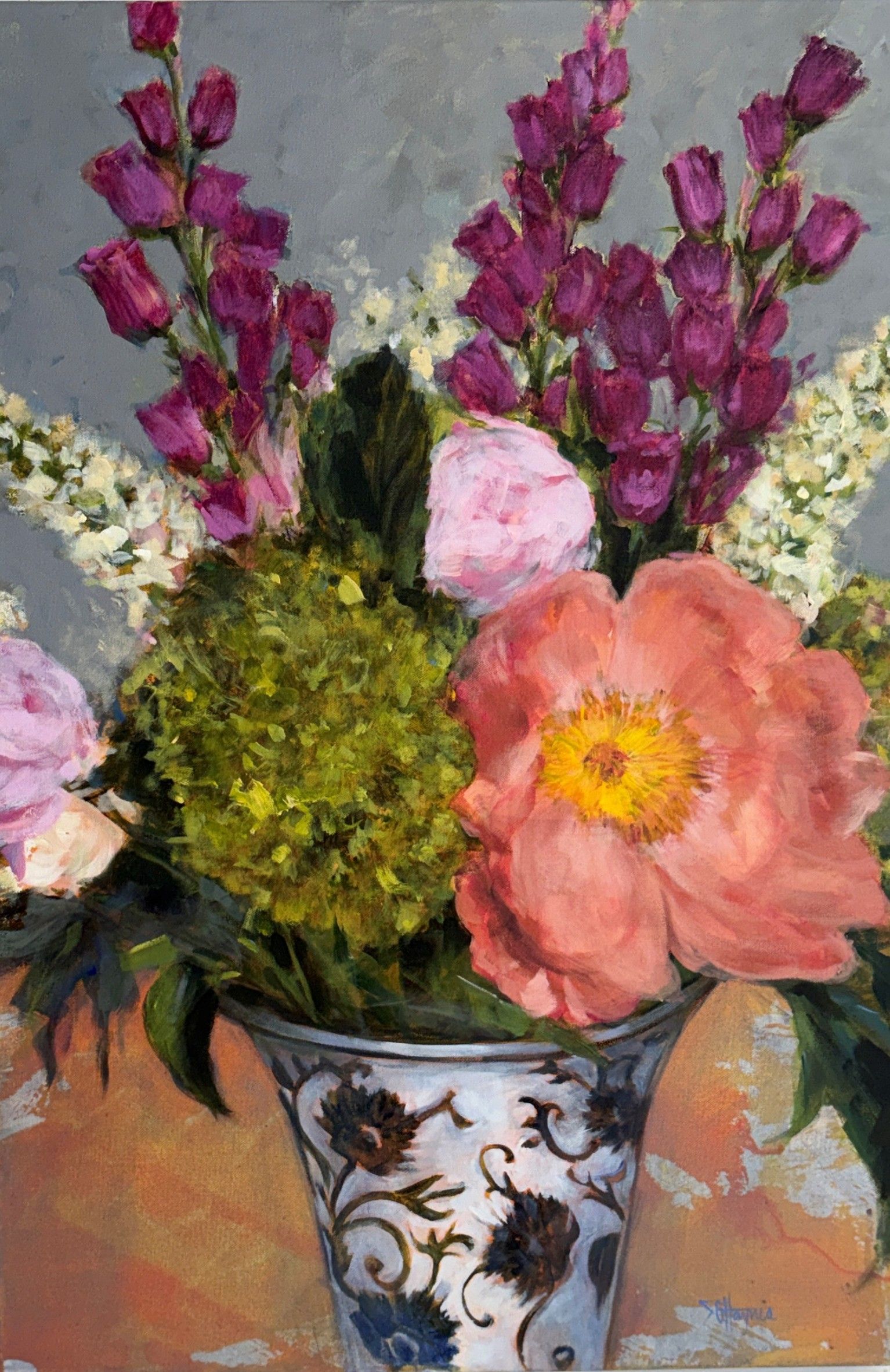 Still life of a floral bouquet in a blue-and-white vase with pink, purple, and white flowers