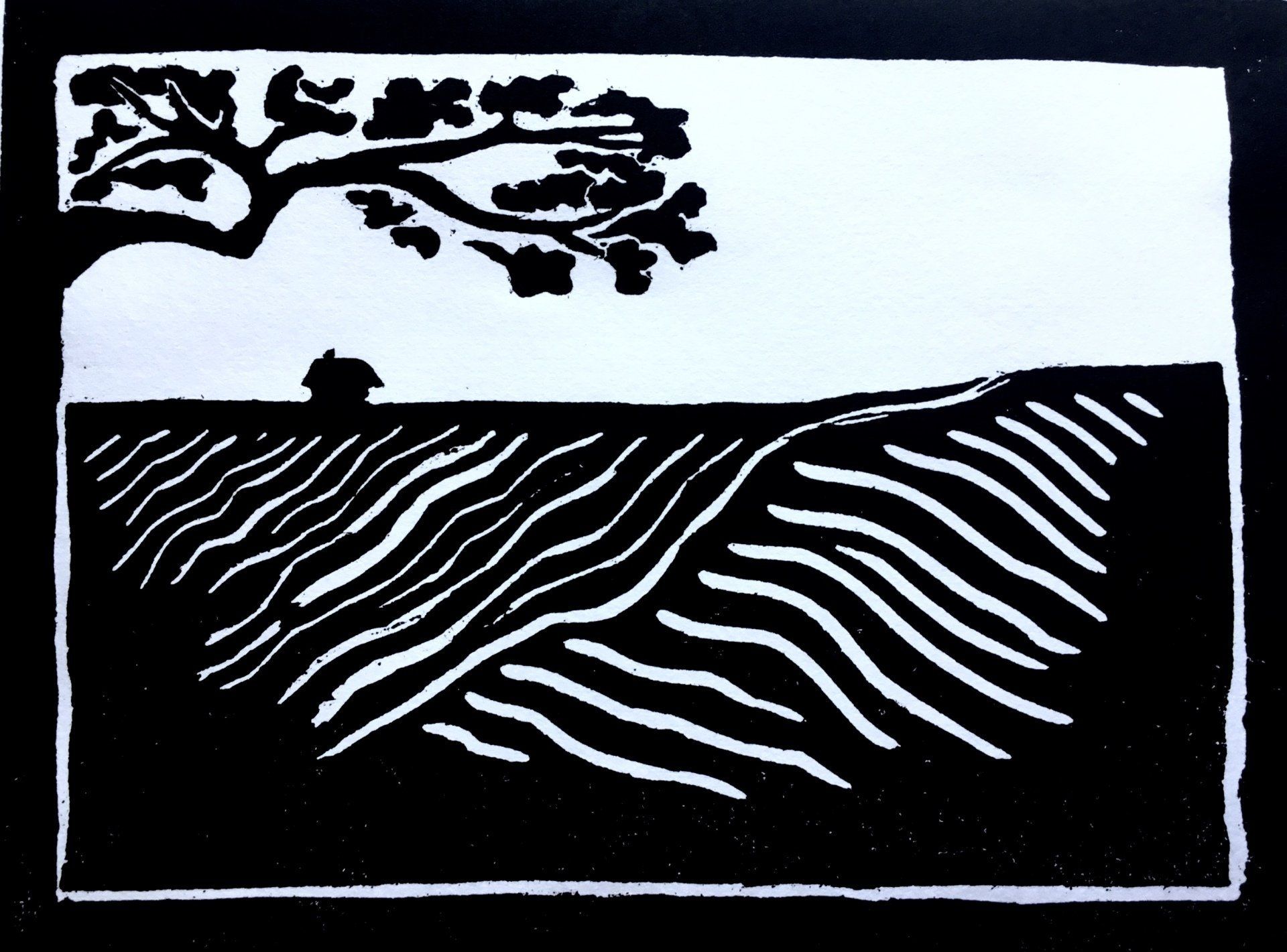 A black and white drawing of a tree in a field