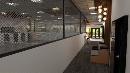 Long hallway with a grated wall overlooking a space; benches, lights.