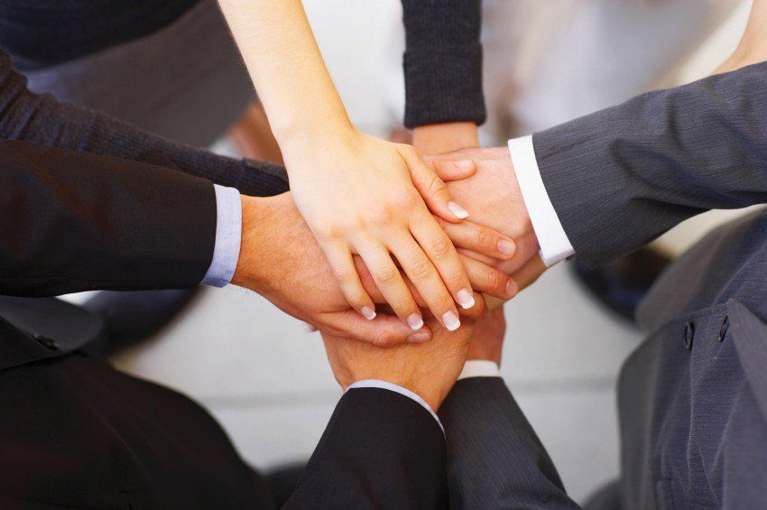 commitment in business- hands in together
