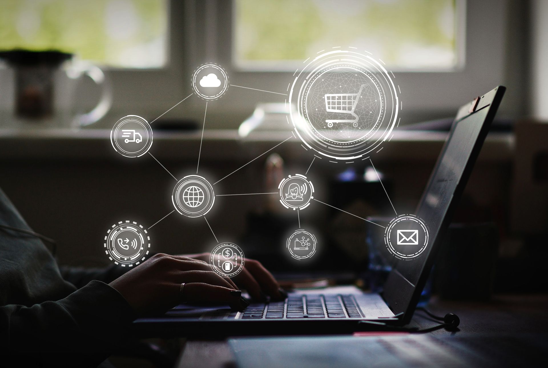 a person is typing on a laptop computer with a shopping cart coming out of the screen .