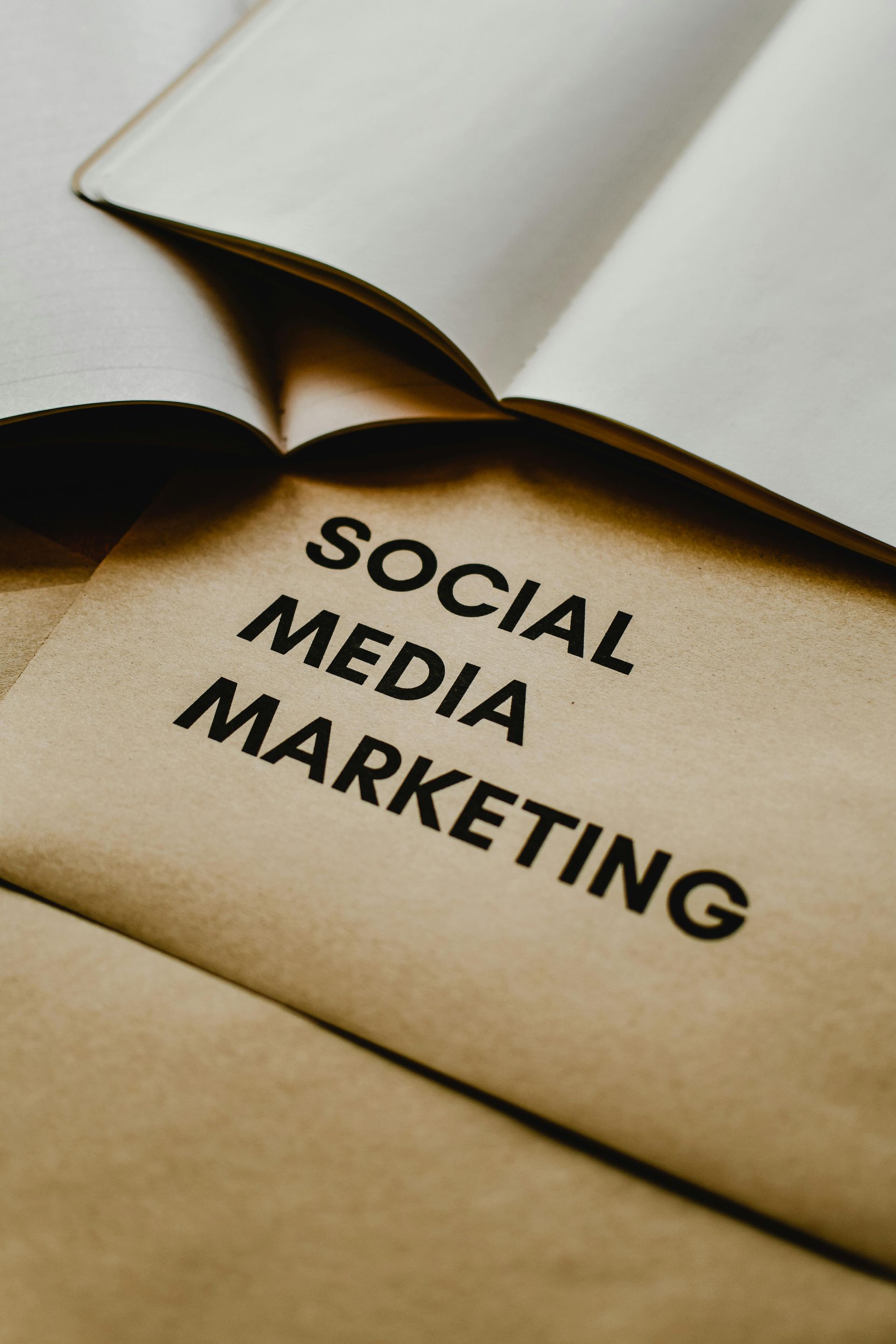 A book is open to a page that says social media marketing