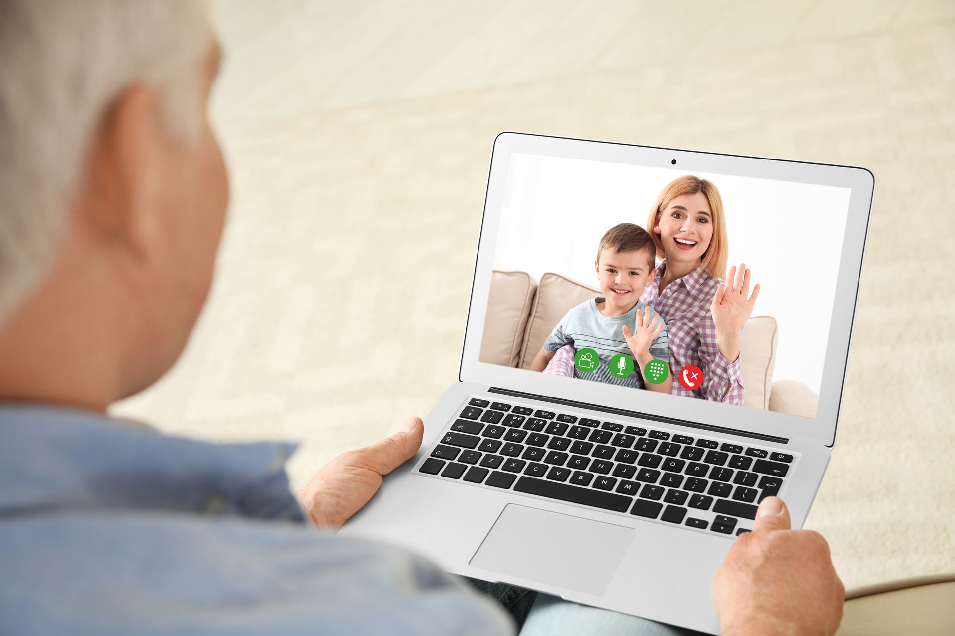 Closeup view of senior man talking with family members via video chat at home