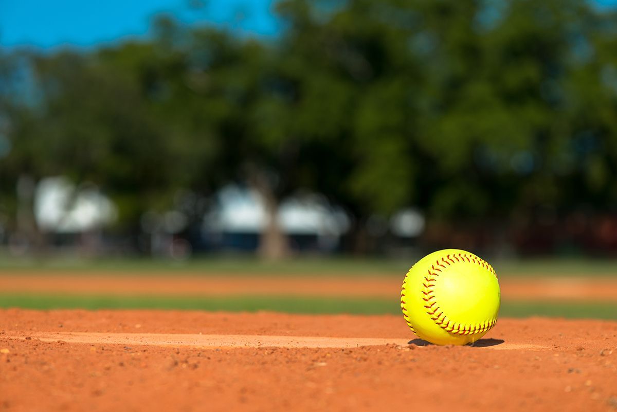 Yellow softball on pitchers mound