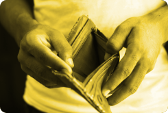 A person is holding an empty wallet in their hands