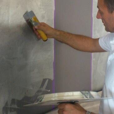 Man Adding Cement On The Wall — Artizans International Specialised Paint Finishes in Robina, QLD