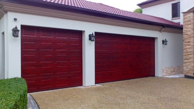 Maroon Garage Door Of A House — Artizans International Specialised Paint Finishes in Robina, QLD