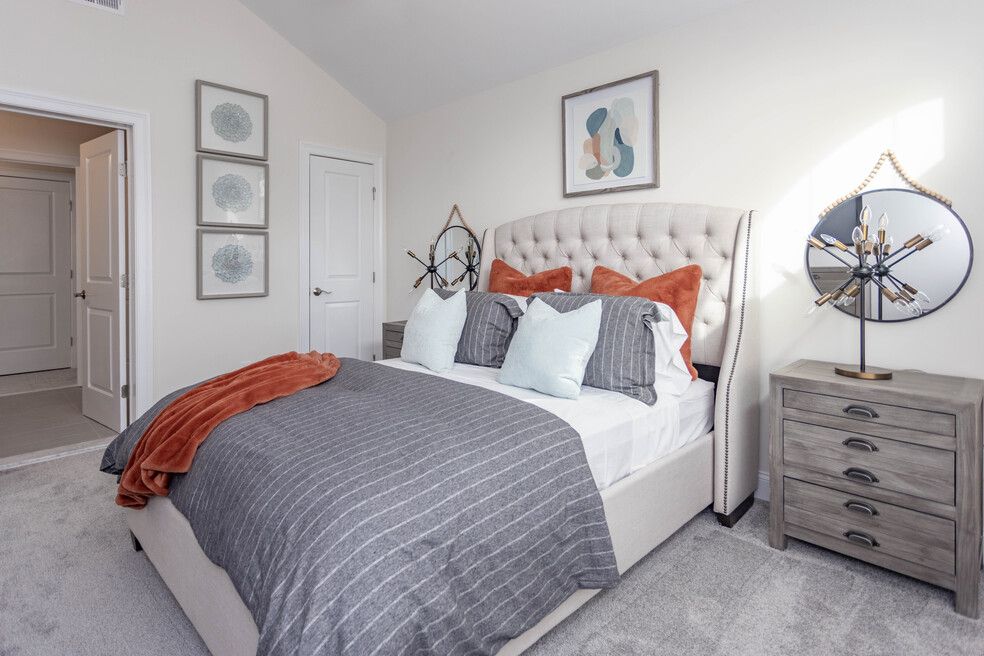 The Villas at Setauket- Bedroom with bed and carpet