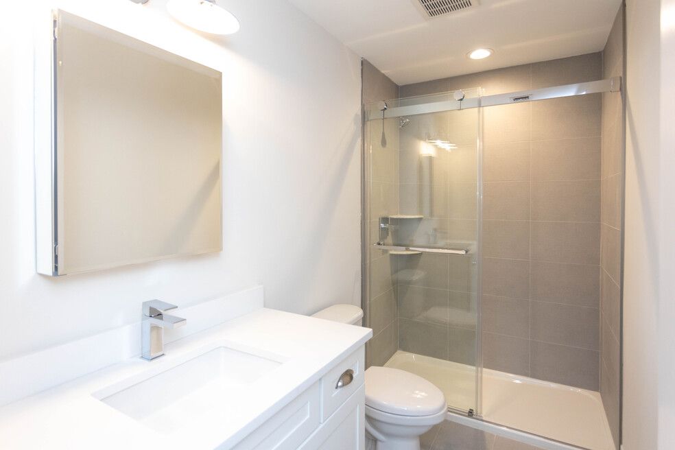 The Port Jefferson -Bathroom with white marble sink and toilet